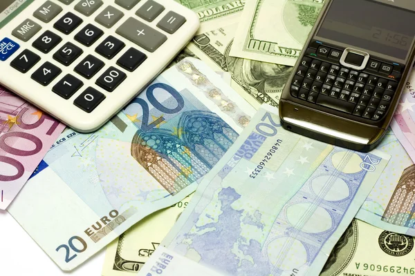 Dólar, billetes en euros, calculadora y teléfono móvil — Foto de Stock