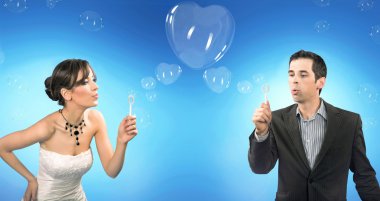 Wedding couple blowing heart shaped romantic soap bubbles clipart