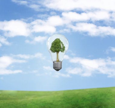 Green energy symbol over blue sky clipart