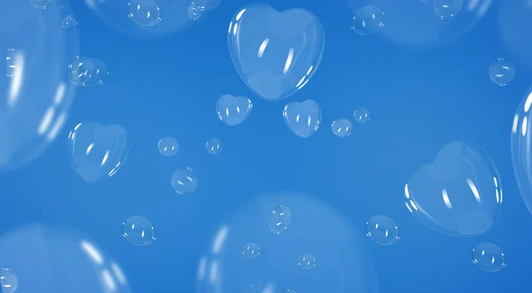 Bolhas de sabão em forma de coração sobre fundo azul — Fotografia de Stock