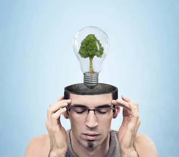 Open minded man with green energy symbol — Stock Photo, Image