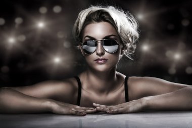 Studio shot of young blonde wearing stylish sunglasses clipart