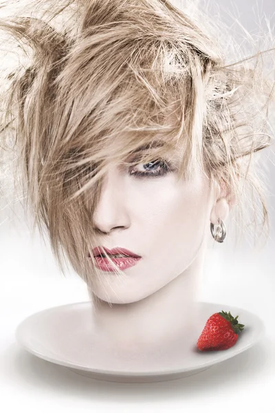 Blonde head and a strawberry — Stock Photo, Image