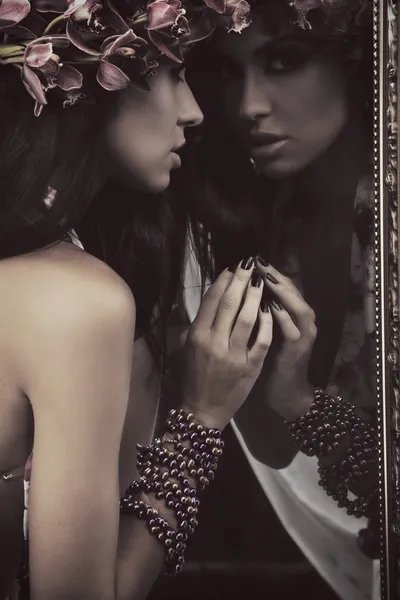 Brunette beauty in a mirror — Stock Photo, Image