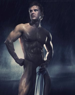 Young handsome athlete standing in the rain clipart