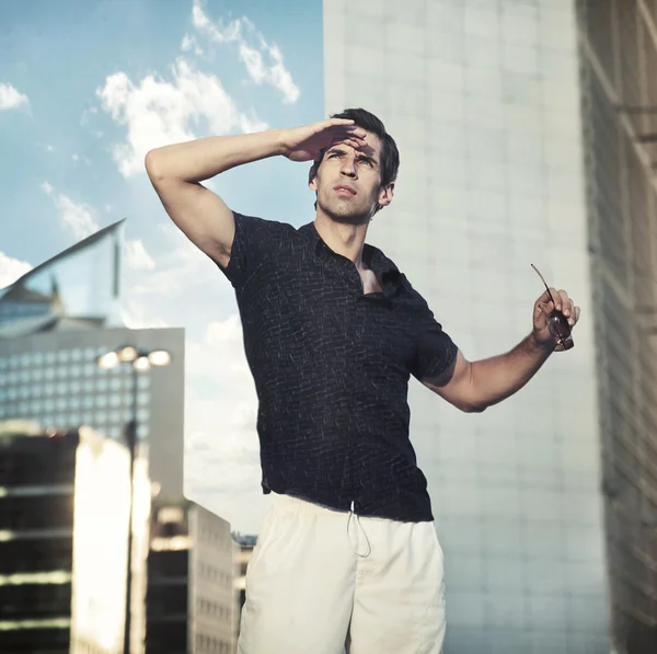 Young handsome man over urban background — Stock Photo, Image