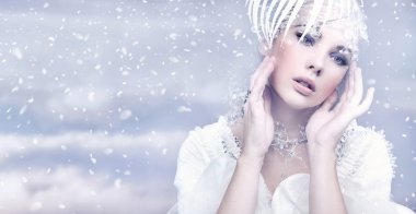 Beauty woman over winter background clipart