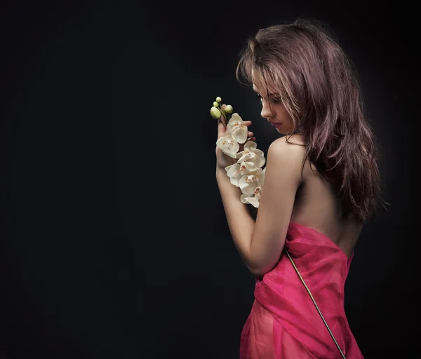 Schöne junge Frau mit weißer Orchidee — Stockfoto