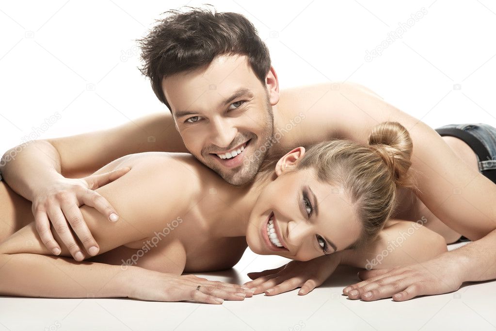Beautiful young couple lying on the bed