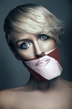 Conceptual photo of woman with the mouth taped up clipart