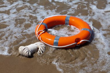 Red lifebuoy in foamy waves clipart