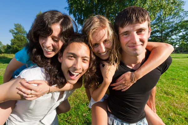 Four young having fun in the park — Stock Photo, Image