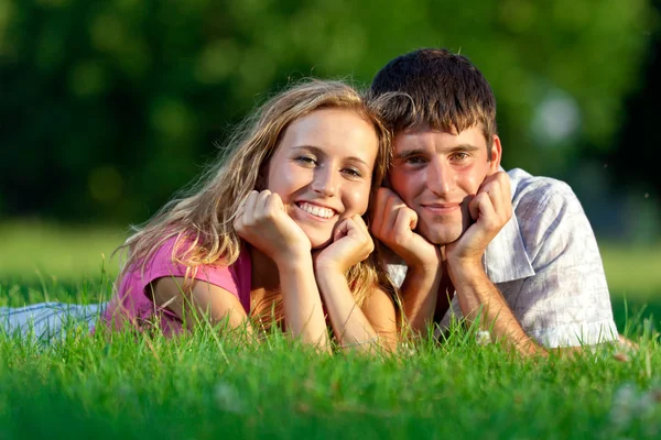 Пара отдыхающих на траве в парке — стоковое фото