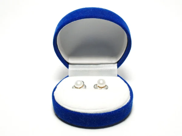 Earrings in a blue box — Stock Photo, Image