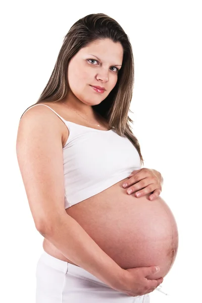 Pregnant woman in white holding her belly — Stock Photo, Image