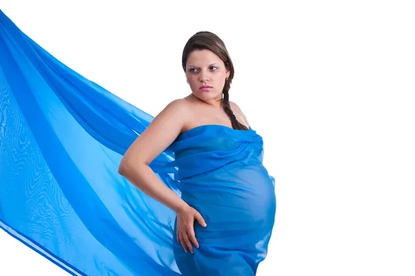 Zwangere vrouw in weefsel houden haar buik — Stockfoto