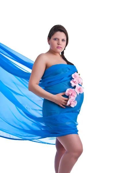 Pregnant young woman in fabric with orchid — Stock Photo, Image