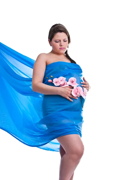 stock image Pregnant young woman in fabric with orchid