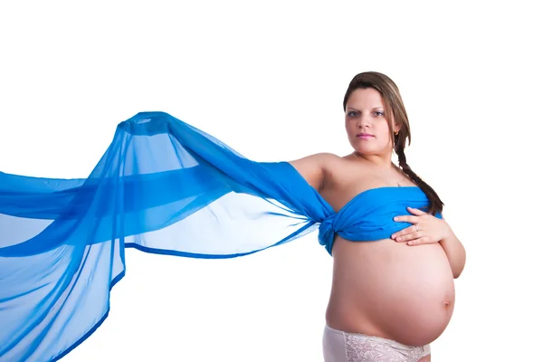 Mujer embarazada en tela azul agitando su mano — Foto de Stock