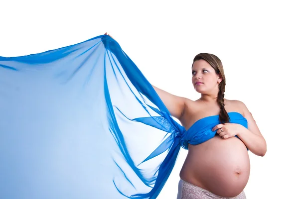 Hamile kadın elini sallayarak mavi kumaş — Stok fotoğraf