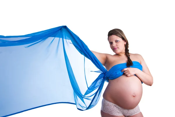Mujer embarazada en tela azul agitando su mano — Foto de Stock