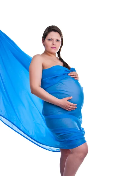 Zwangere vrouw in weefsel houden haar buik — Stockfoto