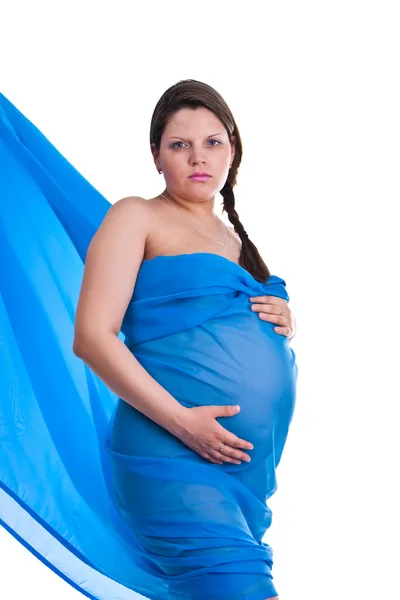 Mujer embarazada en tela sosteniendo su vientre — Foto de Stock