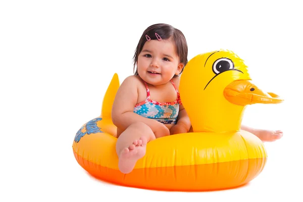 Adorable child sitting on a duck Stock Image