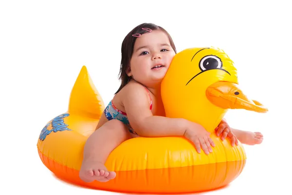 Adorable child sitting on a duck Royalty Free Stock Images