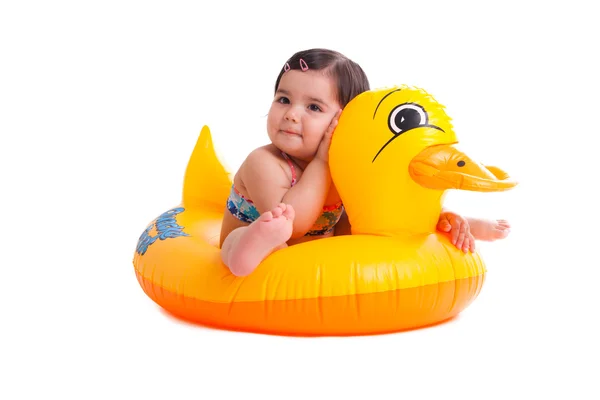 Adorable child sitting on a duck Stock Picture