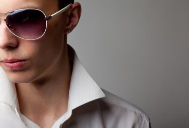 Young handsome man in sunglasses clipart