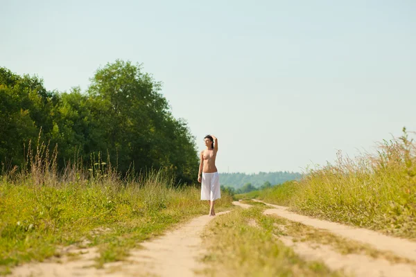 stock image Beautiful girl walking in the field