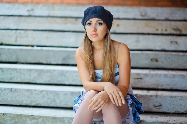 Young woman sitting on a step — Stock Photo, Image