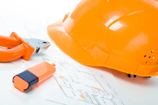 Building concept, helmet blueprints highlighter and pliers — Stock Photo, Image