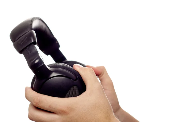 Black headphones in hands — Stock Photo, Image