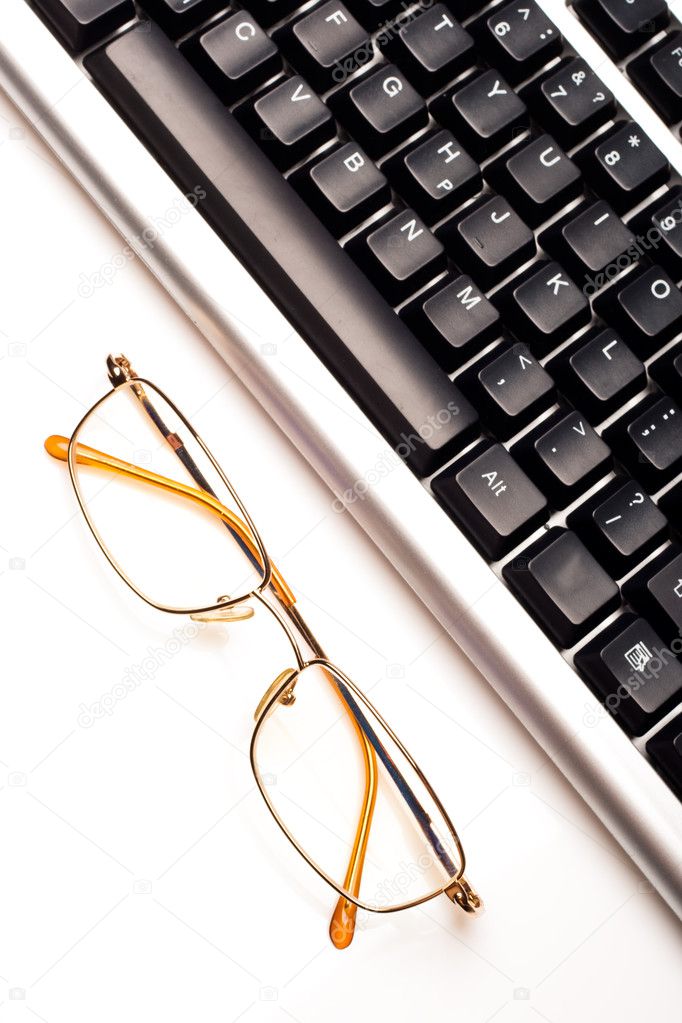 Fragment of keyboard with glasses