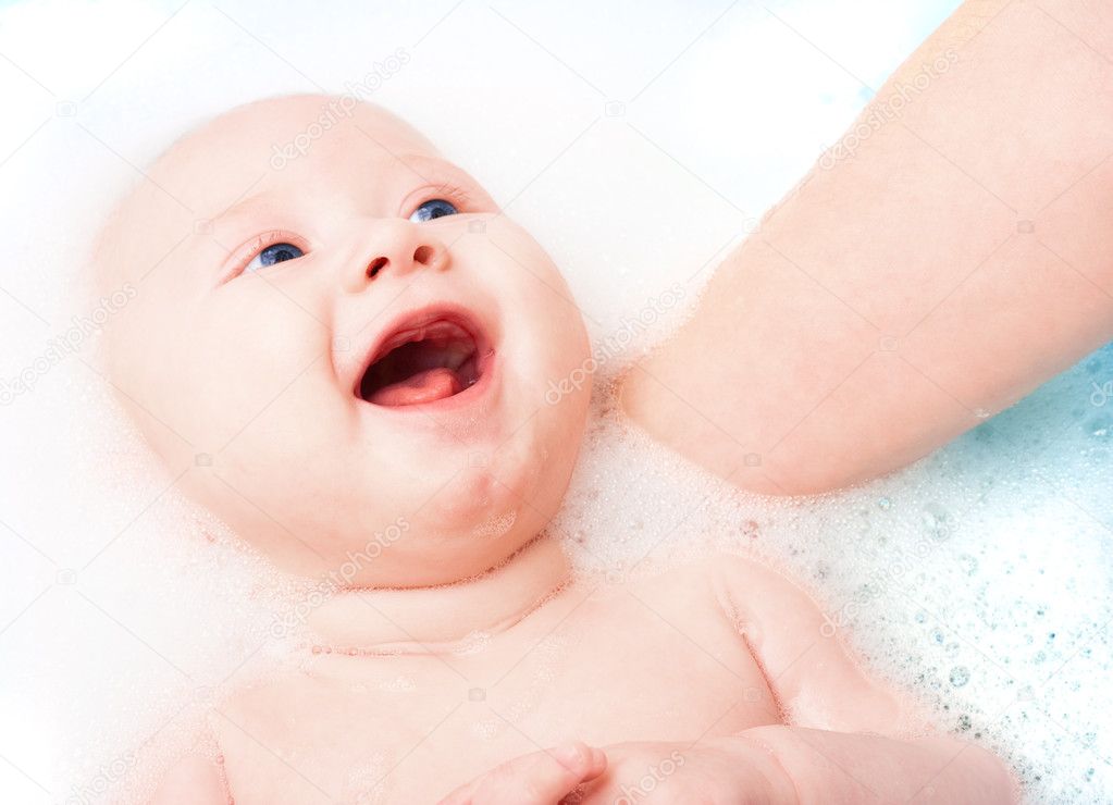 Baby smiling in bathroom