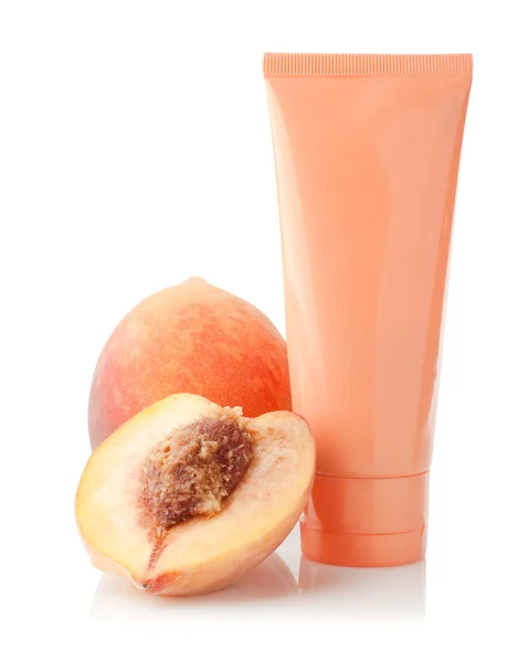 Peach and tube cosmetics — Stock Photo, Image