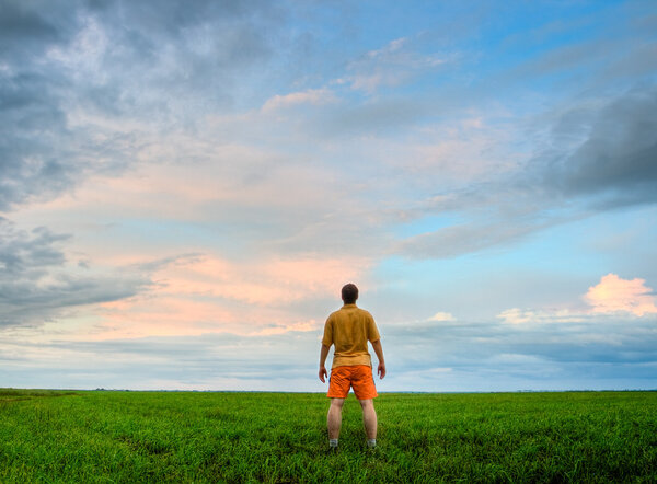 Man standing on green field