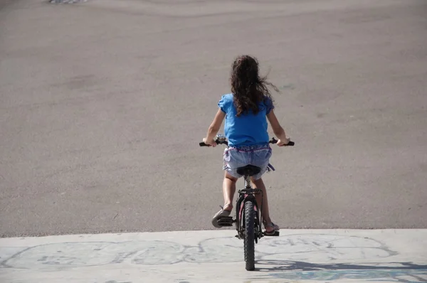 stock image GIRL RIDING BICYCLE .