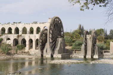 Aqueduct with water wheel in Hama, Syria clipart