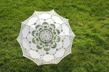 Beautiful sun umbrella on the green lawn clipart