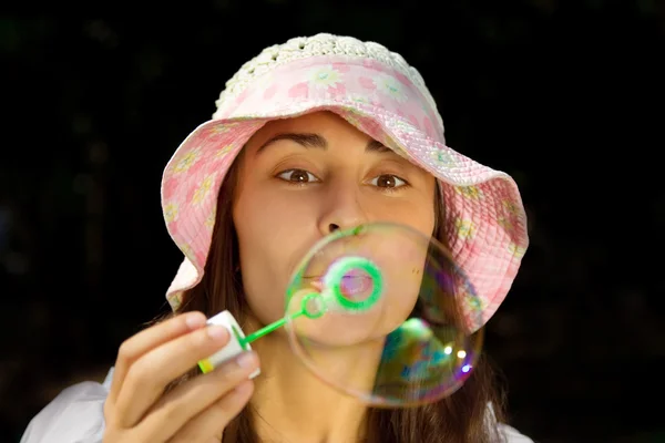 stock image Portrait of a funny young girl blowing bubbles