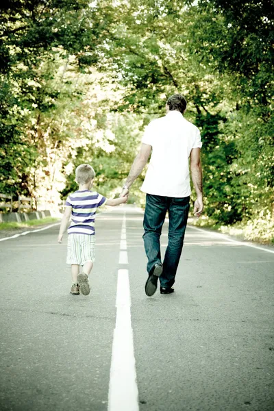 Father with his son go away hand to hand — Stock Photo, Image