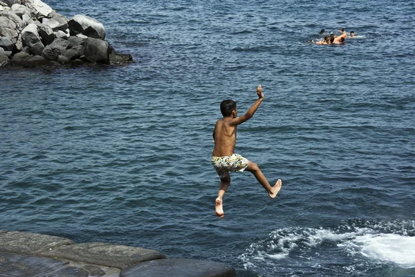 stock image Child jumping in the sea