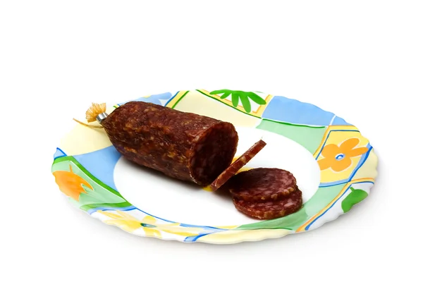 Salami piece on a plate. Isolated on a white background. — Stock Photo, Image