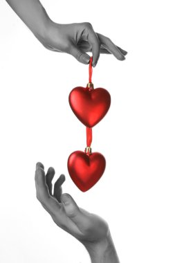 Two hands holding red hearts clipart