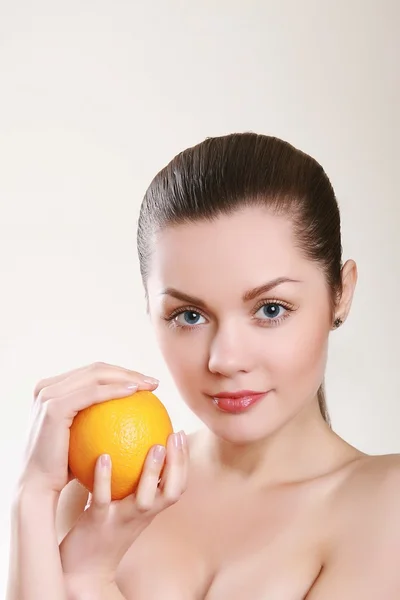 Young woman with orange isolated on white — Stock Photo, Image