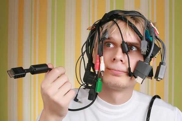 stock image Young man holding different wires