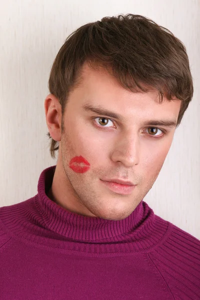 Handsome young man with kiss on cheek — Stock Photo, Image